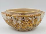a white bowl with a gold decoration on it