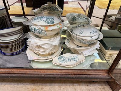 many plates and bowls on display in a glass case