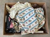 a cardboard box filled with clothes and a pair of shoes