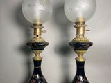 pair of black and gold vase lamps with birds on them