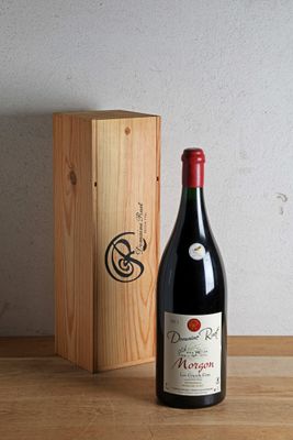 a bottle of wine sitting next to a wooden box