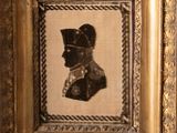 an old picture of a man in a military uniform in a gold frame