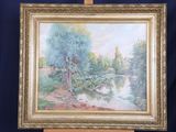 a painting on a easel with a painting of a river in the background