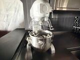a mixer on the counter in the kitchen next to a bowl