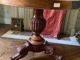 a wooden table with a glass top on a hard wood floor