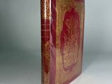 the book is red and gold with gold trimmings on it