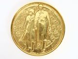 a gold coin with a picture of a man and a woman