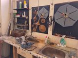 a picture of a workbench in a garage with tools on the wall