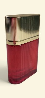 a close up of a red glass container with a gold lid