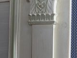 a picture of a white door with decorative molding on it