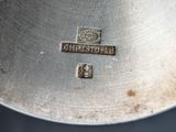 an image of a close up of a silver plate with a logo on it