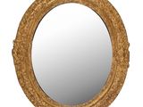 un miroir rond avec un cadre doré sur fond blanc