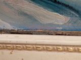 a close up of a painting of a wave on a window sill