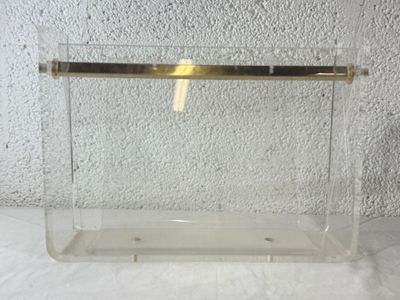 a clear box with a gold handle on a table