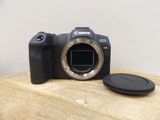 the canon eos is sitting on a wooden table next to a camera