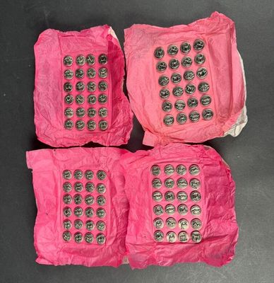 three pink cell phones sitting on top of each other on top of a table