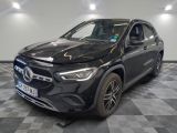 a black mercedes gla suv parked in a showroom
