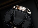 the black purse is hanging on the door handle of the door