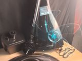 a bottle of wine sitting on a table next to a fan