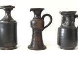 three vases sitting next to each other on a white surface