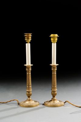 pair of antique brass candlesticks with white candlesticks