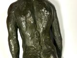 statue of a man standing with his hands in his pockets