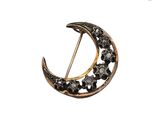 an image of a crescent shaped broochle with black diamonds