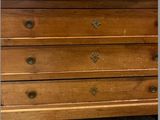 a wooden dresser in a store with a mirror on top of it