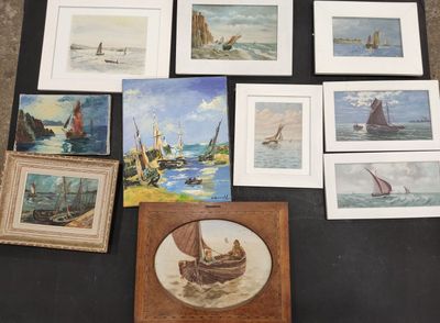 many framed pictures of boats on a table