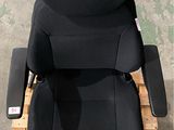 a black chair that is sitting on a pallet