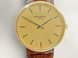 an image of a gold watch with a brown leather strap