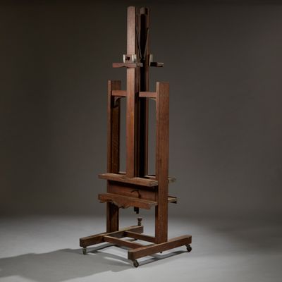 an artist ' s easel with a wooden frame on wheels