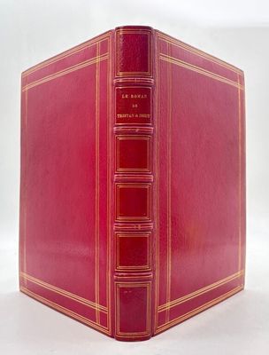 un vieux livre rouge aux bords dorés et à la couverture rouge