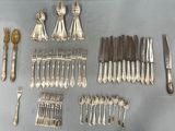 a lot of silver spoons and forks on the table