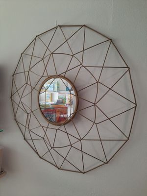a mirror that is hanging on the wall next to a shelf