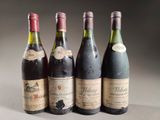 four bottles of wine are lined up on a table