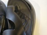 a pair of black sandals that are on top of a table