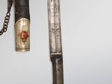 an image of a knife with a chain attached to it