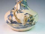 a blue and white vase sitting on a table