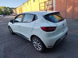 the rear end of a white car parked in a parking lot