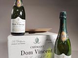 two bottles of wine sitting on top of a box next to each other