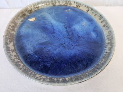 a blue bowl sitting on top of a white table