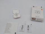 a box of earphones and a charger on a table