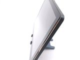 a tablet computer sitting on a stand on a white surface