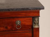 a close up of a wooden dresser with a marble top