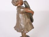 bronze figurine of a girl holding a bird on a marble base
