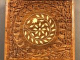 a close up of a wooden box with a design on it