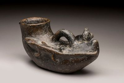 a small vase that has a handle on it