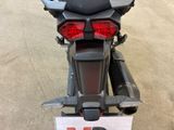 a motorcycle that is parked on the street with a sign in front of it