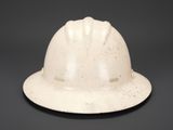 a white hard hat that is sitting on a table